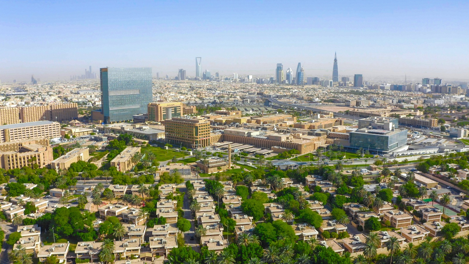 Aerial view of the King Faisal Specialist Hospital & Research Centre campus in Riyadh against the city skyline.