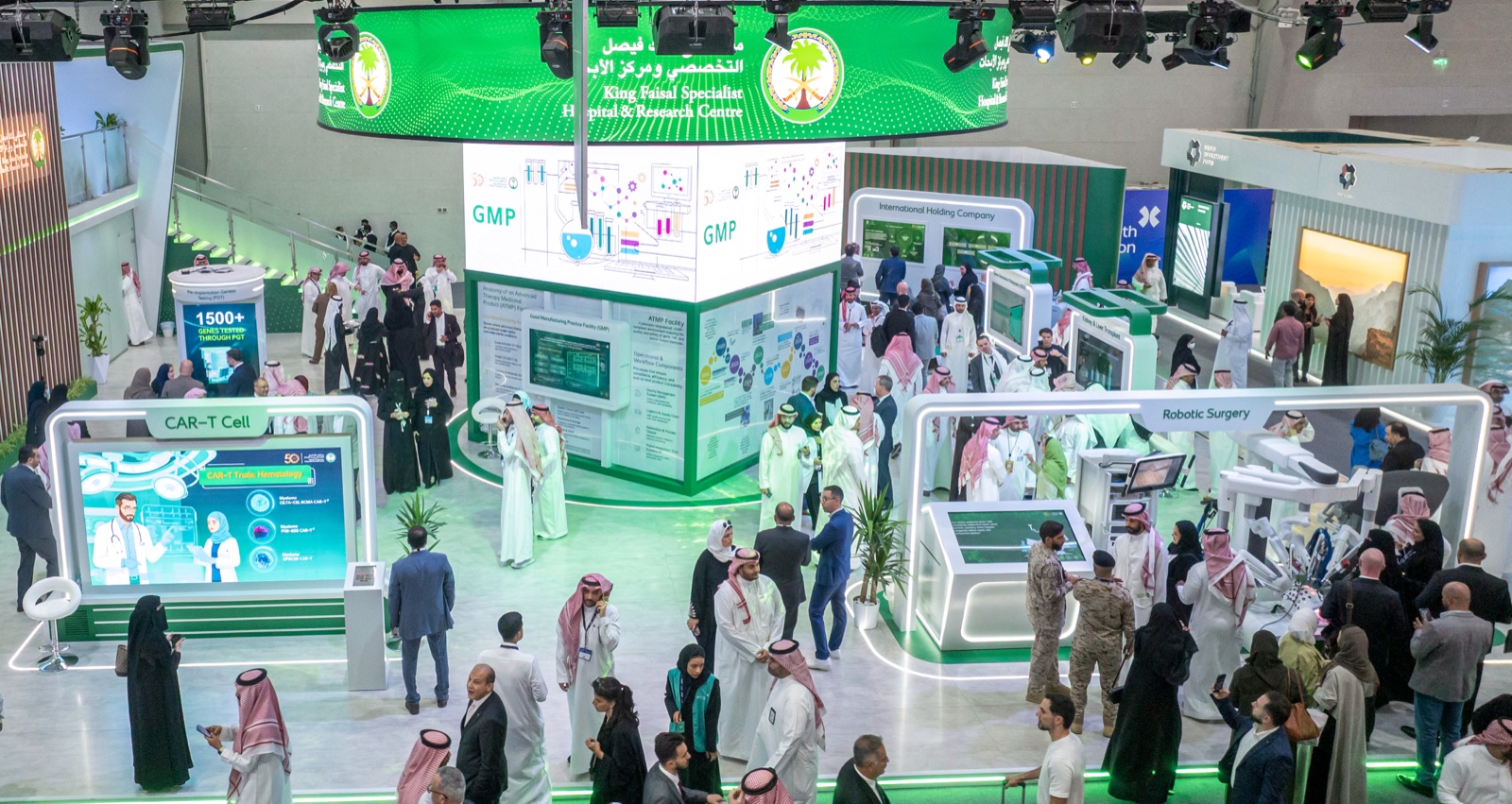 Wide shot of the KFSHRC pavilion at the Global Health Exhibition with CAR-T Cell, GMP, and Robotic Surgery exhibits visible.
